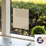 Clear blank submission window decal on glass with laptop, plant, bright outdoor greenery.