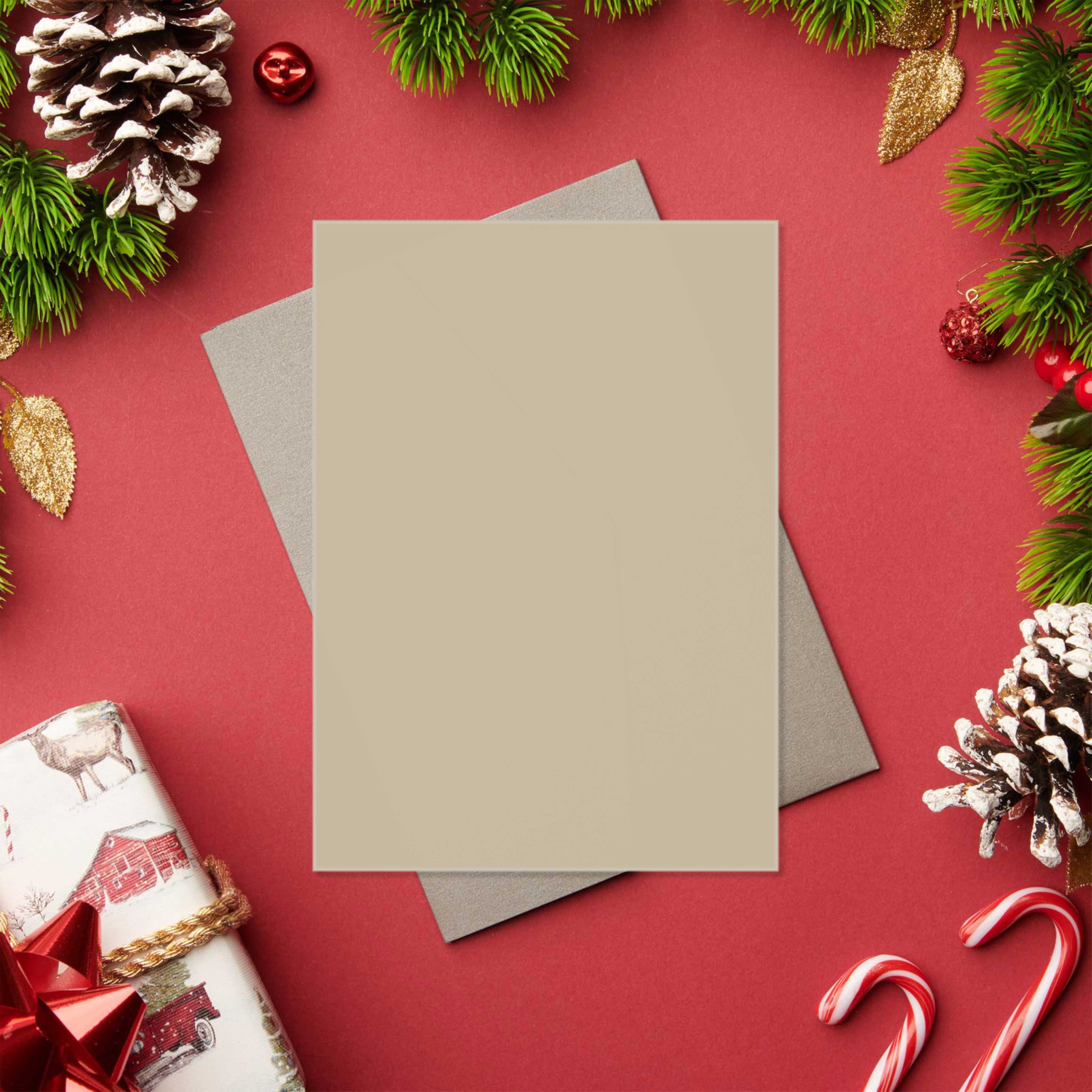 Flat lay Christmas card template with blank space for custom design, surrounded by festive decorations.